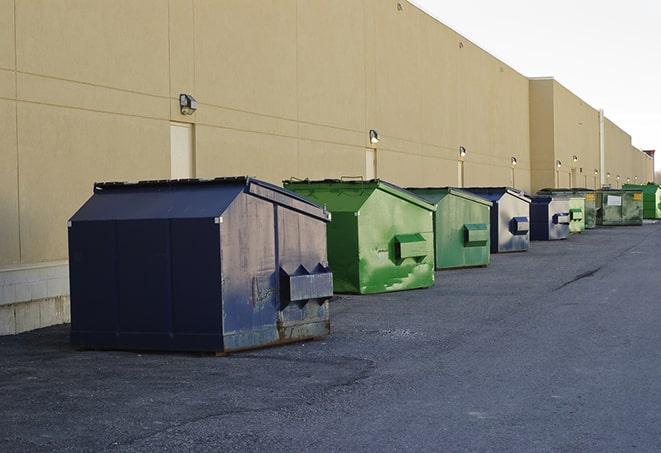 a collection of bright and vibrant dumpsters in a construction zone in Arlington, SD